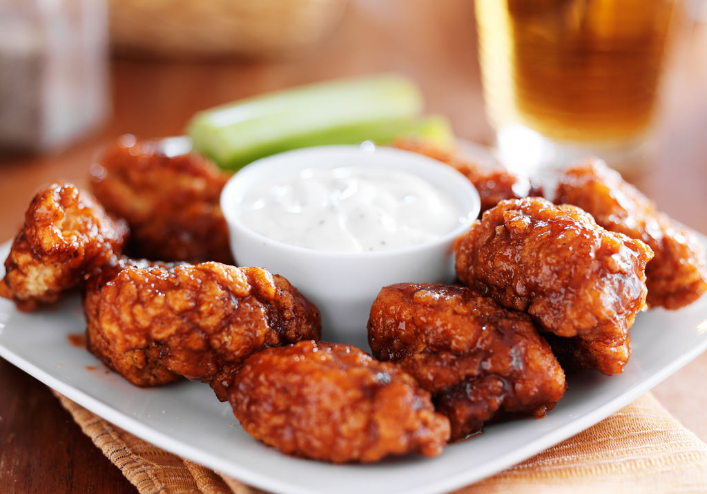 Buffalo wings baked with bbq sauce and served with a dip. King George's.