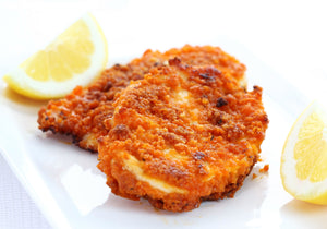 Chicken schnitzel baked and served with lemon wedges. King George's Steak and Seafood.