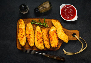 Gluten Free Chicken Fingers baked and displayed with rosemary, ketchup, salt and pepper. King George's Steak and Seafood.