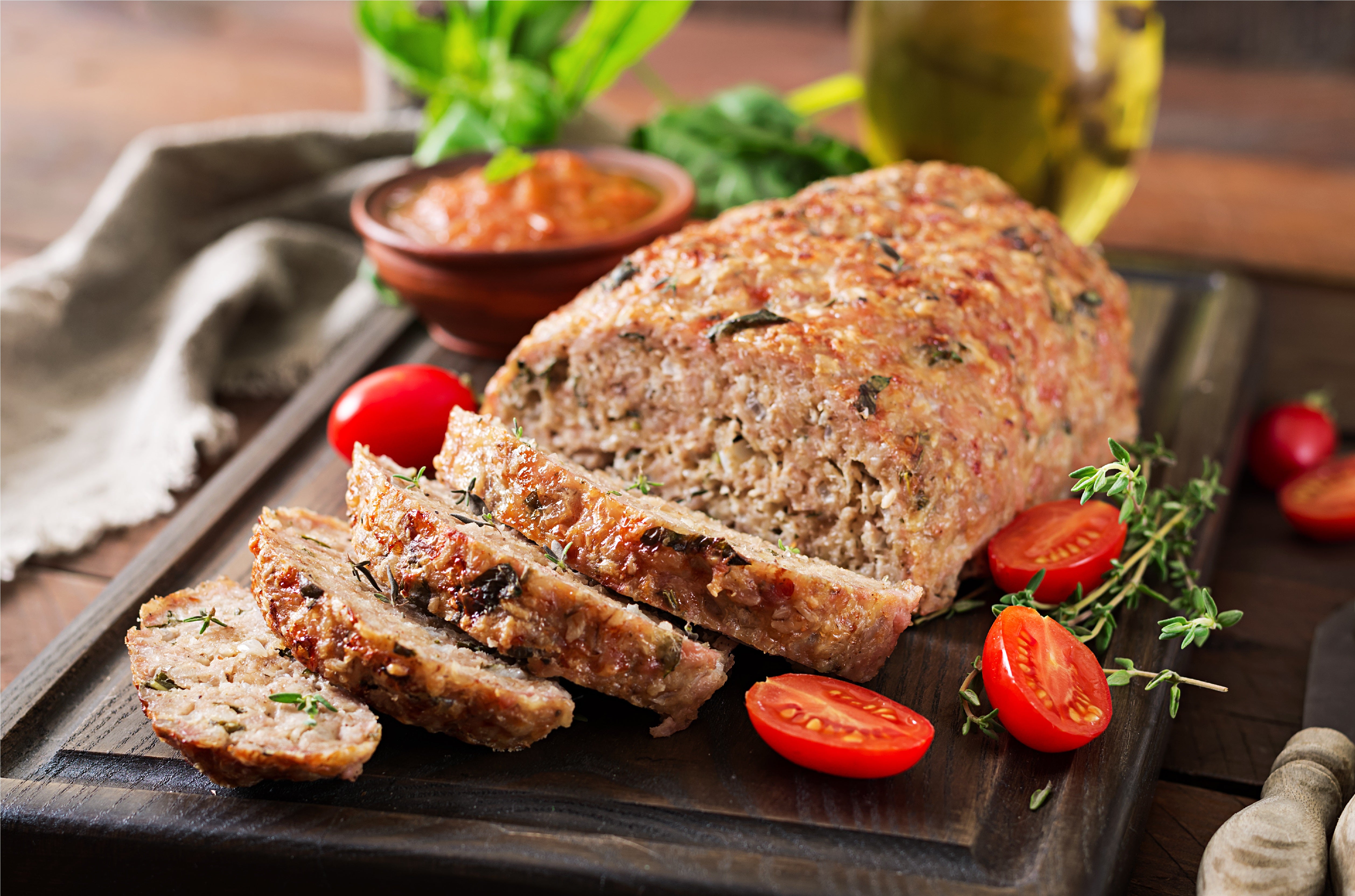 Ground Turkey baked into a loaf and displayed with cherry tomatoes and rosemary. King George's Steak and Seafood.