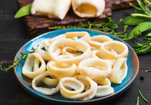 Plain cooked calamari rings displayed with rosemary leaves. King George's Steak and Seafood. 