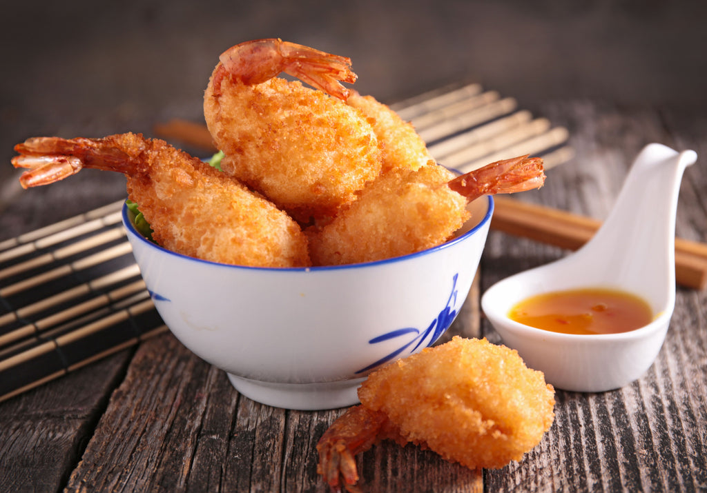 Fried coconut shrimp displayed with chopsticks and shrimp sauce. King George's Steak and Seafood.