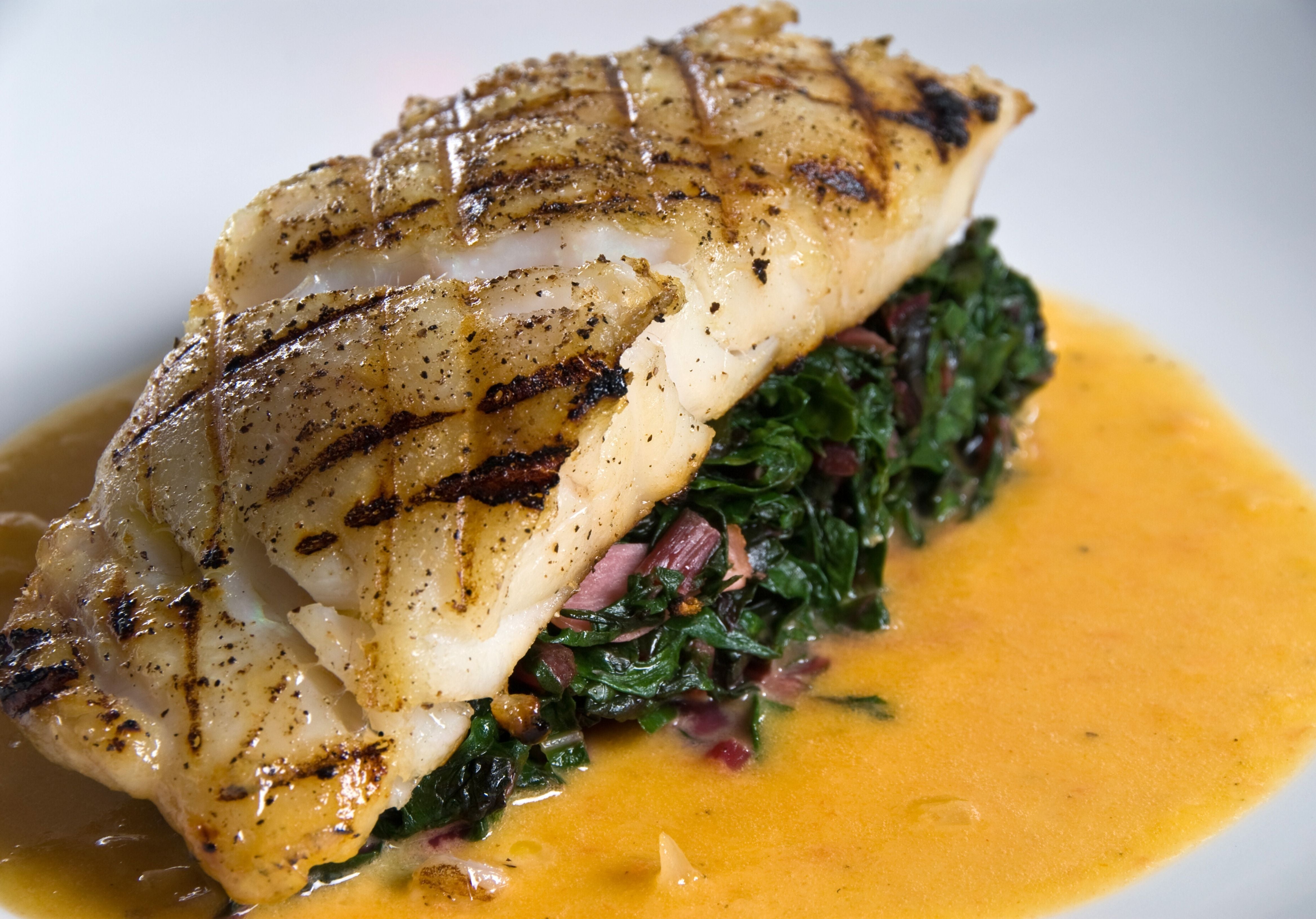 Grouper Fillet served on top of a bed of cooked veggies and a golden curry. King George's Steak and Seafood. 