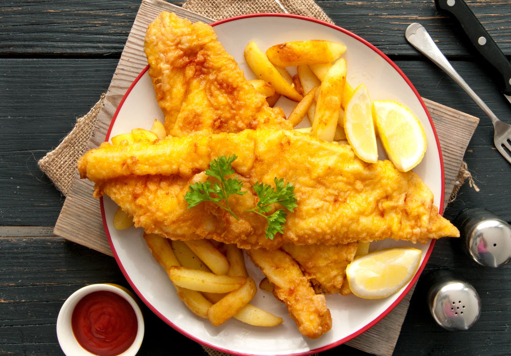 Haddock fillets breaded and baked; served with fries, lemon, ketchup, salt an pepper. King George's Steaks and Seafood.