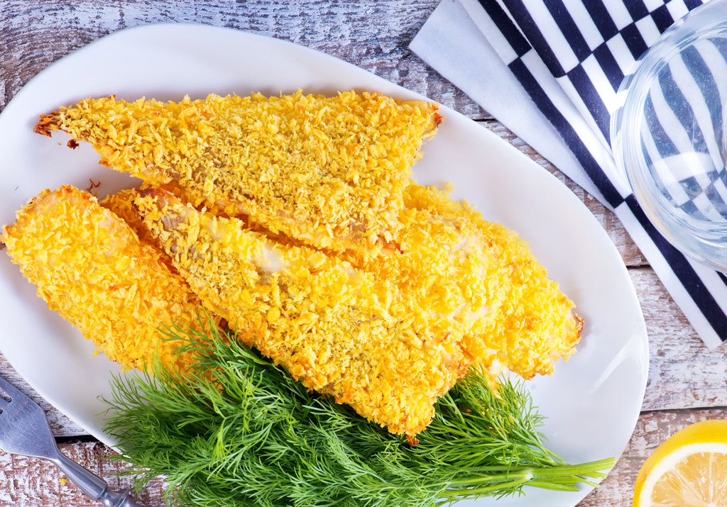 Baked breaded perch garnished with lemon and fresh dill. King George's Steaks and Seafood.