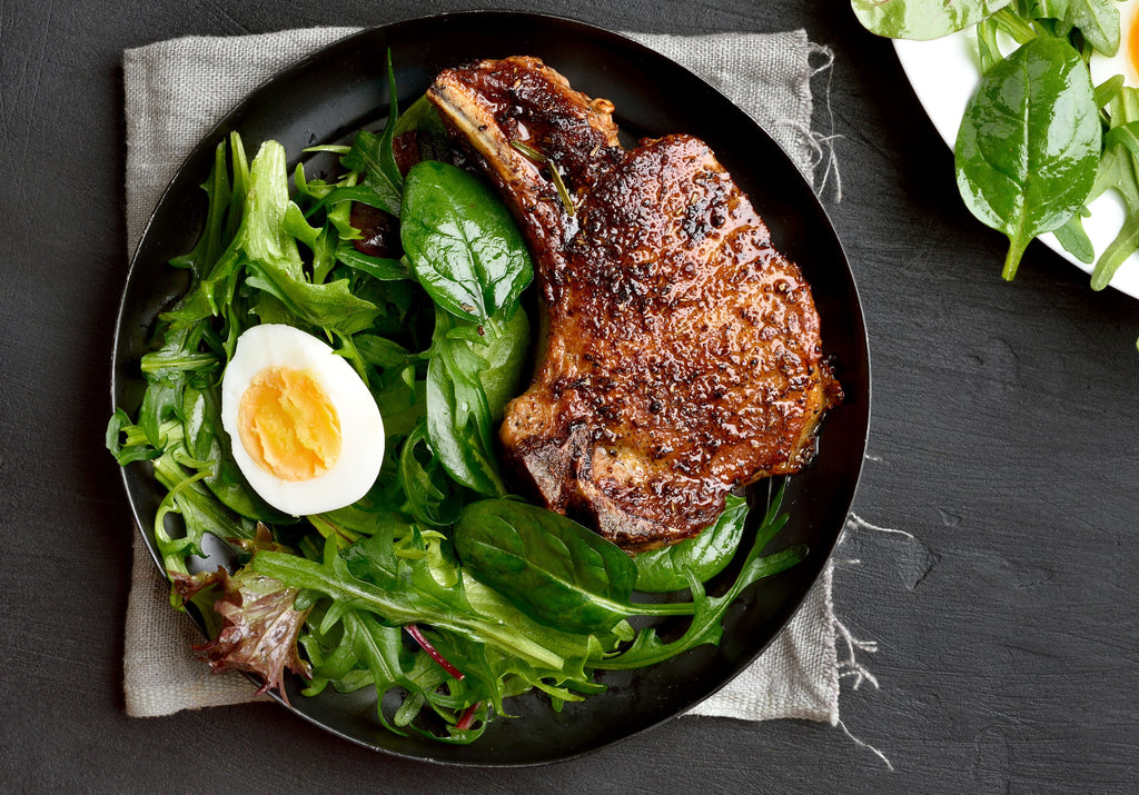 Grilled pork chop served with salad and boiled half egg. King George's Steaks and Seafood.