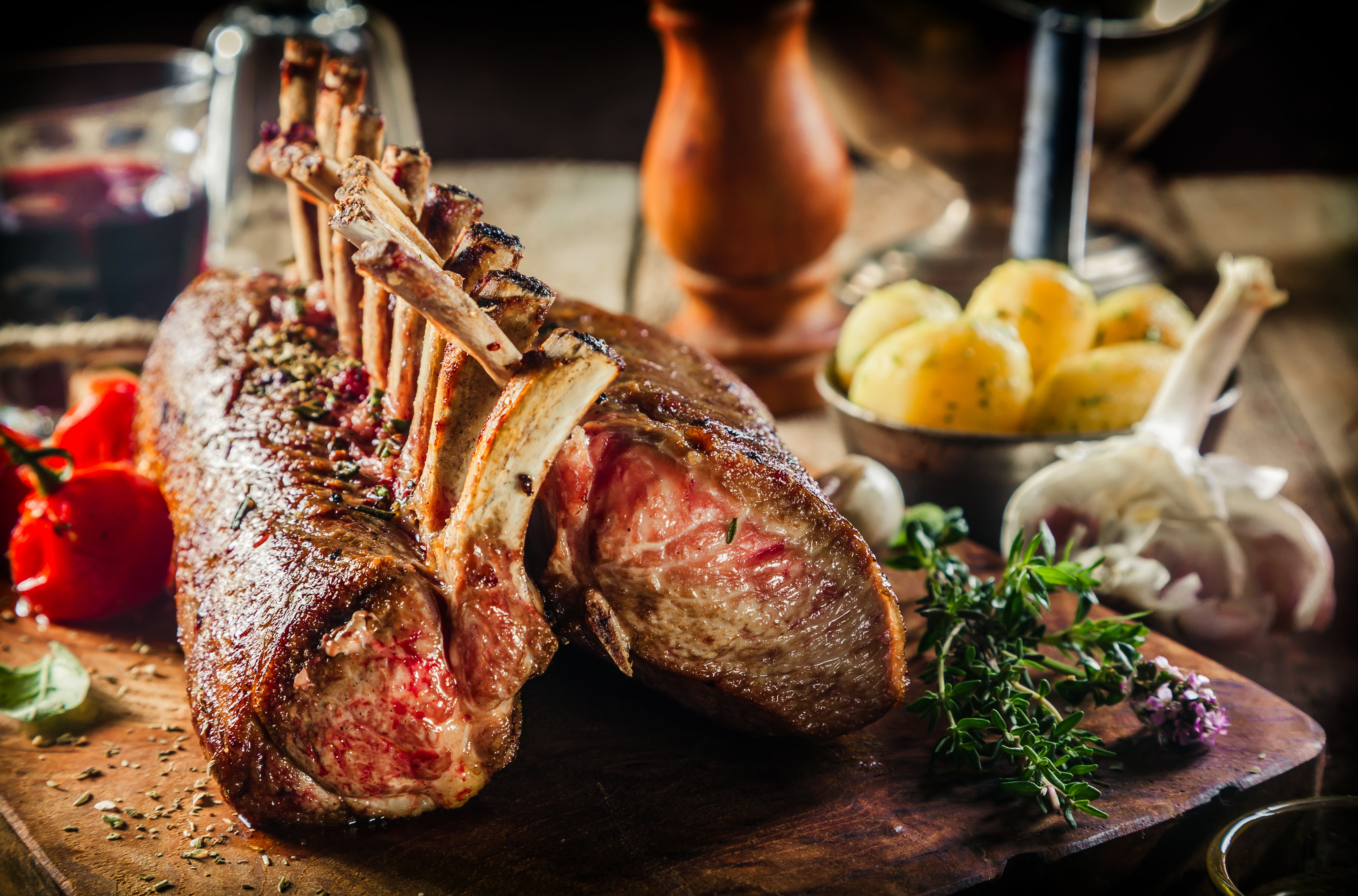 Baked entire rack of lamb displayed with cooked vegetables. King George's Steaks and Seafood.