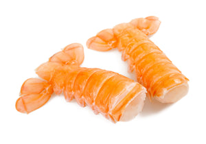 Two raw Scampi Tails displayed on a white background. King George's Steaks and Seafood.