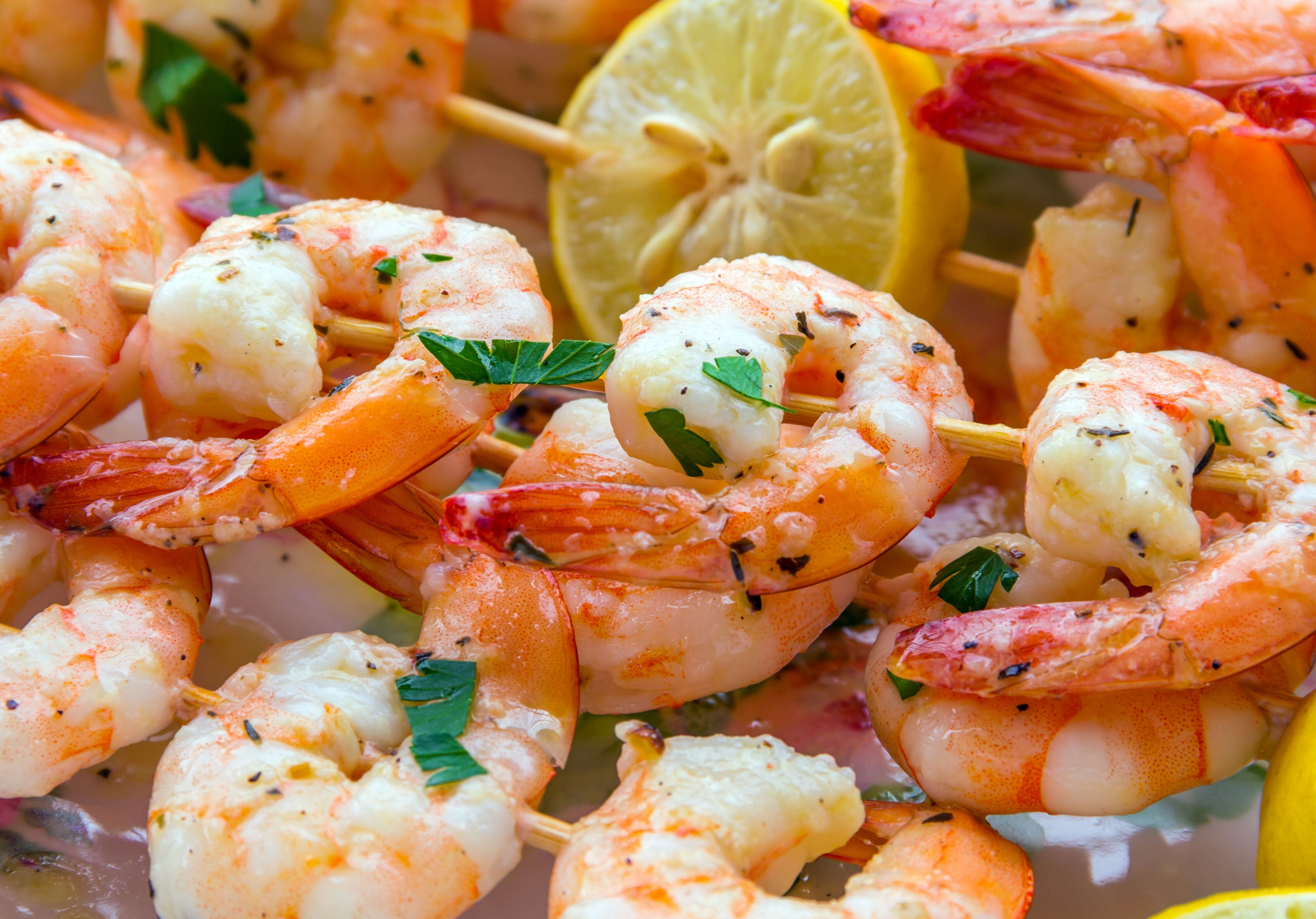 Cooked Shrimp Skewers with spices and lemon. King George's Steaks and Seafood.