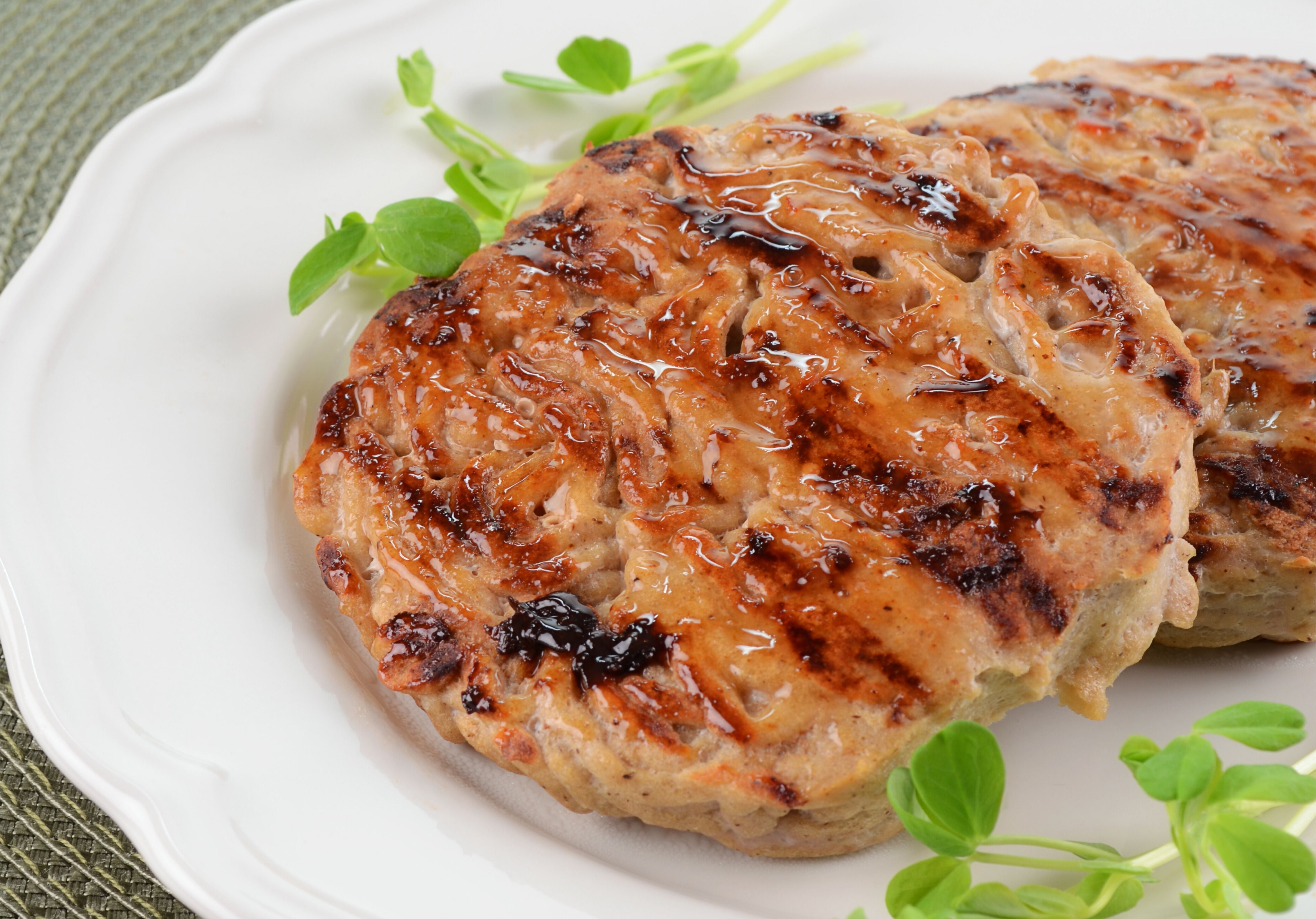 Grilled Turkey Burgers displayed on a plate with green leaves. King George's Steak and Seafood.