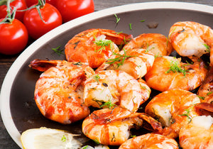 Cook wild Red Shrimp with spices and displayed with fresh tomatoes. King George's Steak and Seafood.  