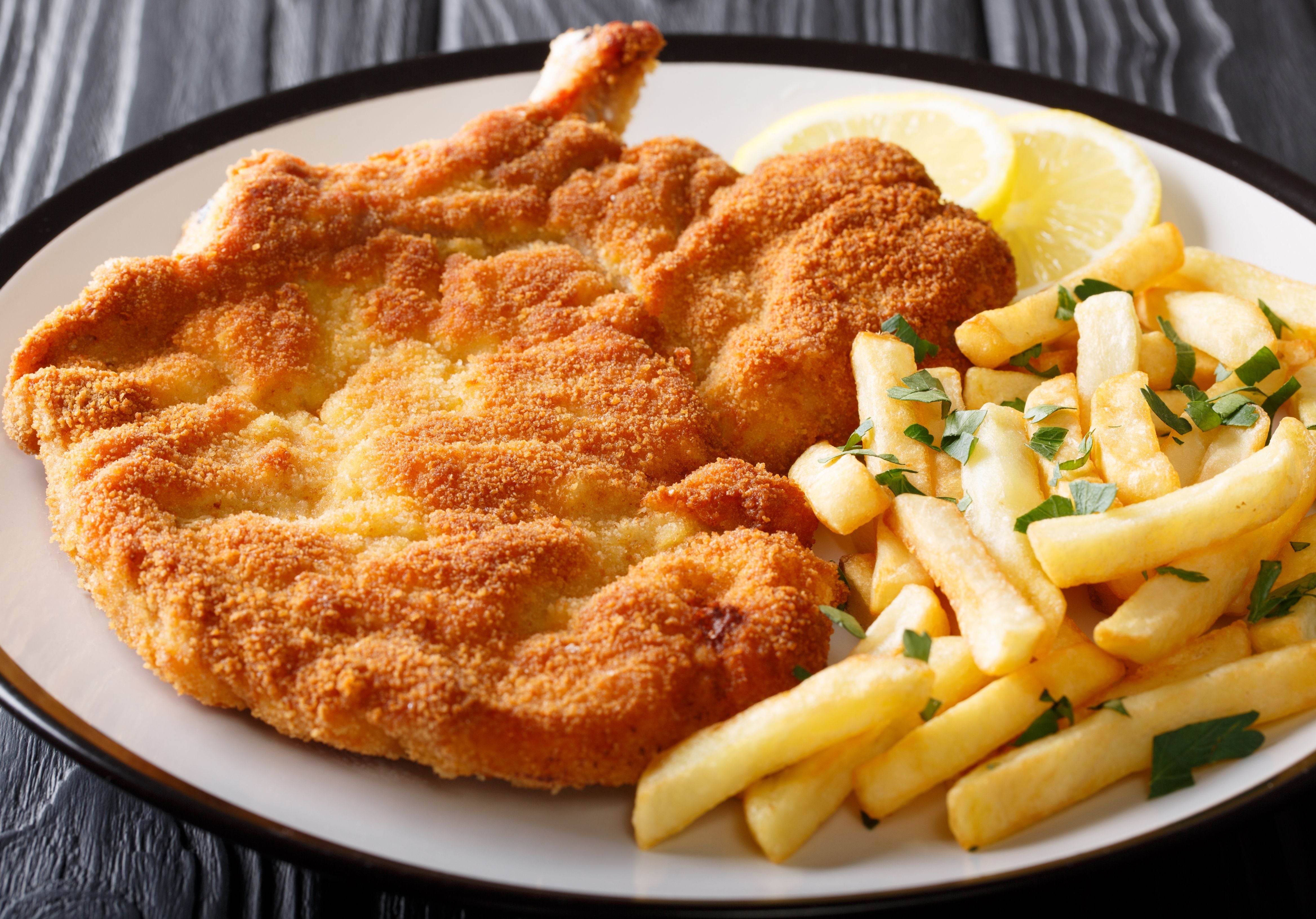 Fried Veal Schnitzel served with French fries and lemon wheeels. King George's Steak and Seafood.