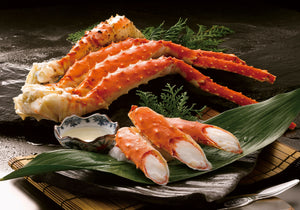 Cooked King Crab legs displayed on top of green leaves. King George's Steak and Seafood.